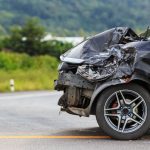 Car accident scene showing damaged vehicles and injured individuals, indicating a potential personal injury case.