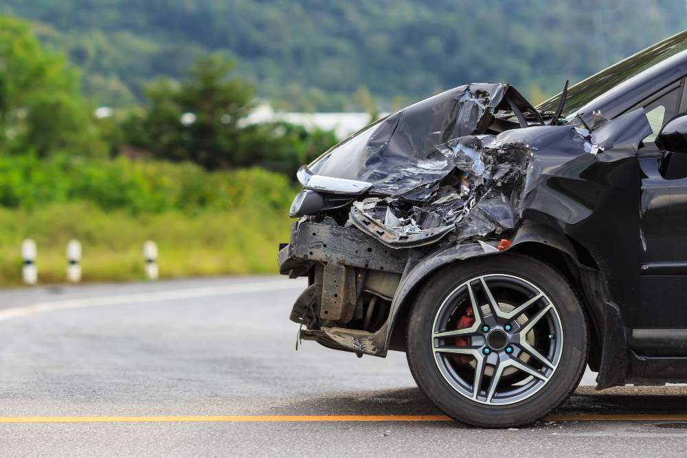 Car accident scene showing damaged vehicles and injured individuals, indicating a potential personal injury case.