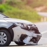 Car accident scene showing damaged vehicles and injured individuals, indicating a potential personal injury case.