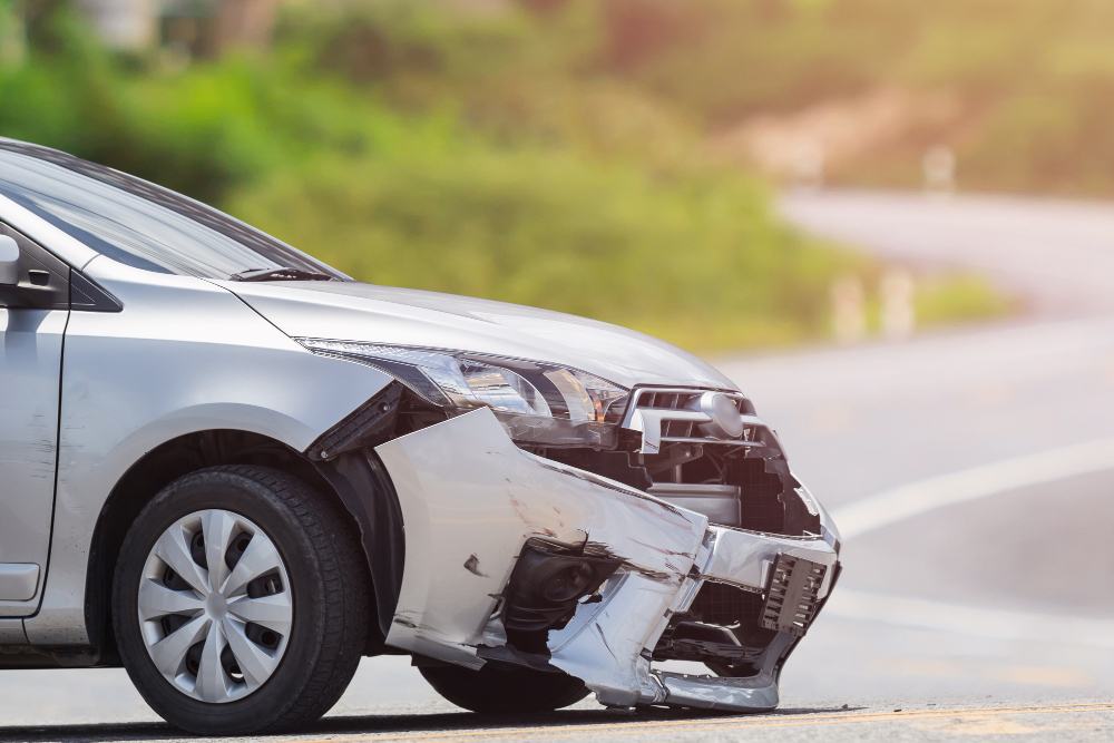 Car accident scene showing damaged vehicles and injured individuals, indicating a potential personal injury case.