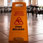 Yellow caution wet floor sign in a building representing slip and fall premises liability