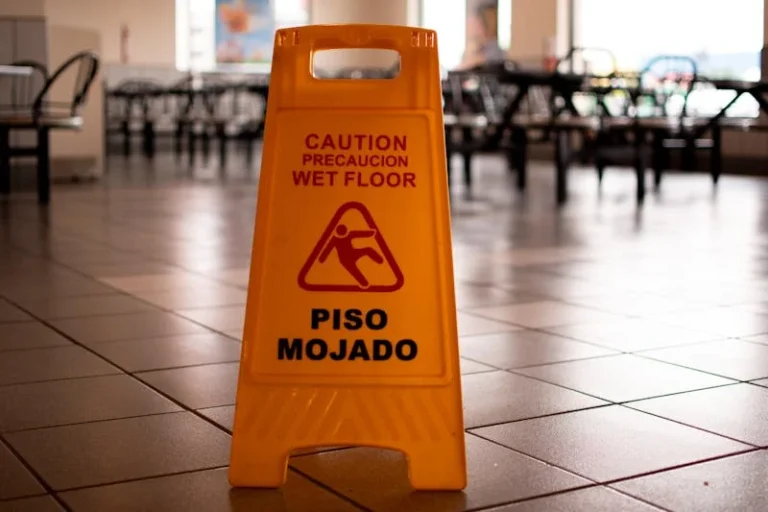 Yellow caution wet floor sign in a building representing slip and fall premises liability