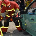 Firefighters performing rescue at a vehicle crash scene representing catastrophic injury cases