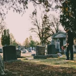 Person holding flowers at a cemetery representing wrongful death claims in Chicago