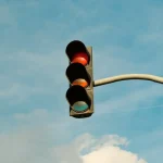 Red traffic light at a city intersection representing red light accident and intersection crash claims