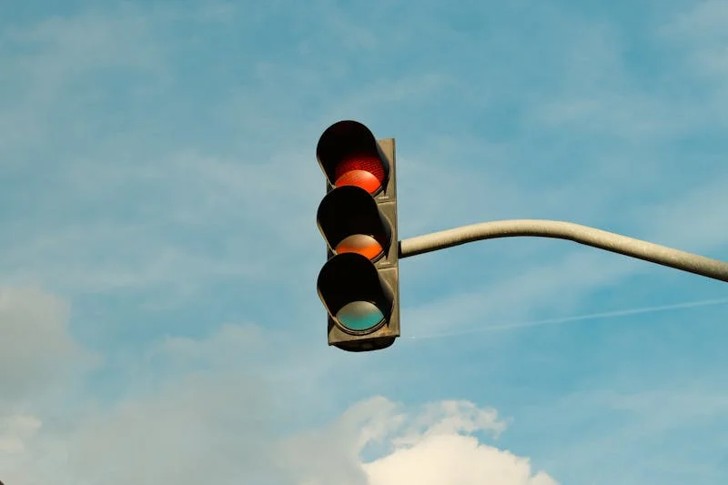 Red traffic light at a city intersection representing red light accident and intersection crash claims